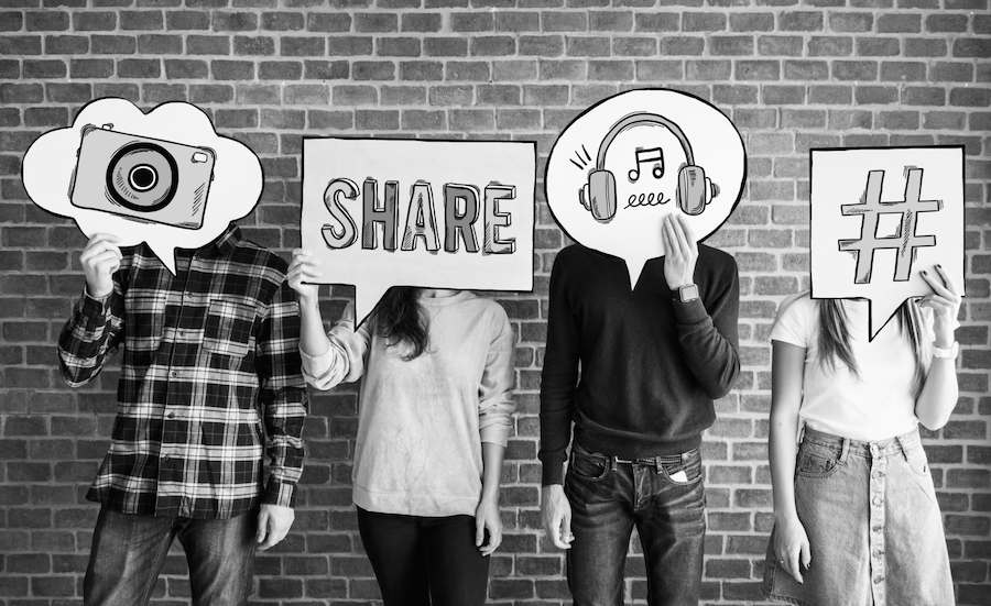 group of four people standing with speech bubbles on them